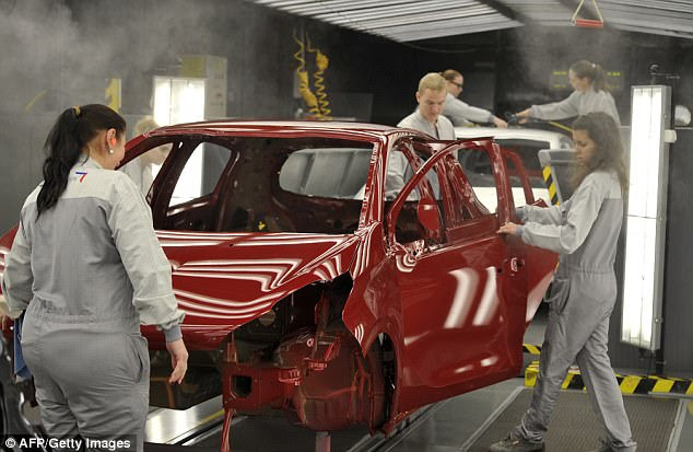 France is to end sales of petrol and diesel vehicles by 2040 the government announced today (file photo of French employees at work on the assembly line of the Peugeot 208)
