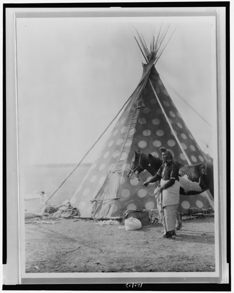 Description of  Title: A Blackfoot tepee.  <br />Date Created/Published: c1927.  <br />Summary: Blackfoot Indian, (Bear Bull?) holding horse outside tipi.  <br />Photograph by Edward S. Curtis, Curtis (Edward S.) Collection, Library of Congress Prints and Photographs Division Washington, D.C.