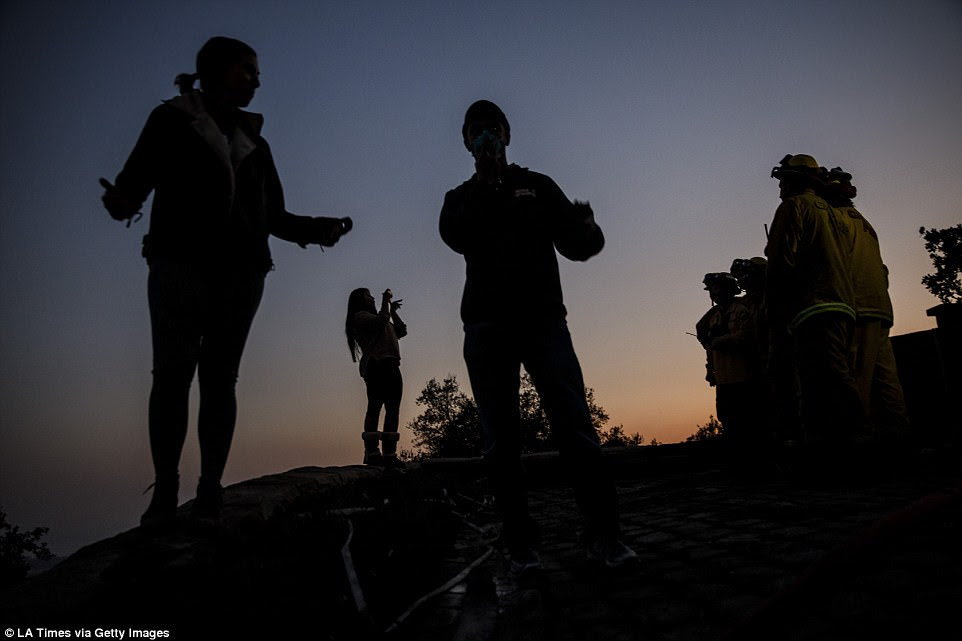 On Sunday, the Behrman family gathered at dusk outside their home that was destroyed by the Thomas Fires and thanked the firefighters that were mopping up residual heat in the rubble