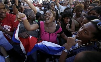 Supporters of Cuba's government chant revolutionary slogans as they argue with members of the Cuban dissident group 'Ladies in White' in Havana, Cuba, Wednesday, Feb. 23, 2011. by Pan-African News Wire File Photos