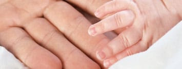 Photo: Adult and infant hands together