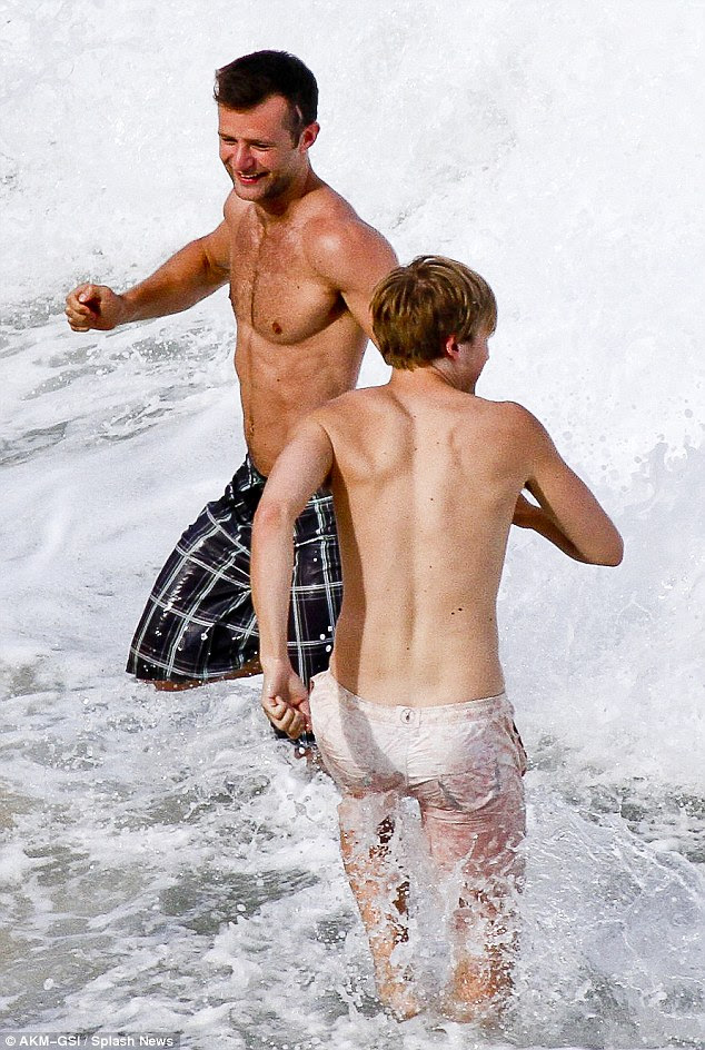 Causing a splash: The pop pair had fun in the waves