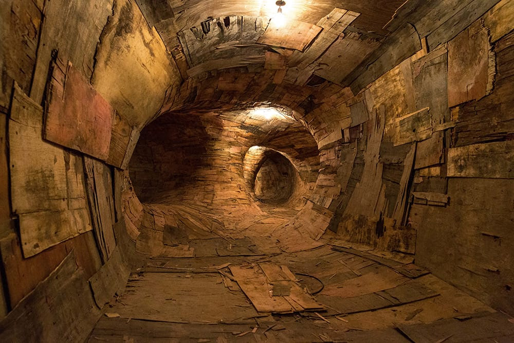 Artist Henrique Oliveira Constructs a Cavernous Network of Repurposed Wood Tunnels at MAC USP Artist Henrique Oliveira Constructs a Cavernous Network of Repurposed Wood Tunnels at MAC USP wood installation architecture