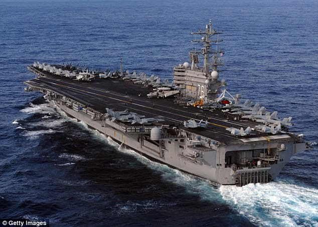 Reports in South Korea claim the US President is bolstering the deployment by sending the USS Ronald Reagan (pictured) and the USS Nimitz to the Sea of Japan next week