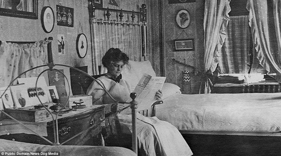 A woman sits and reads the newspaper at Baylor University, Texas, in her room in the early 1900s 