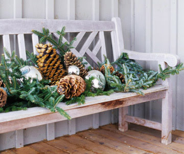 White Weathered Bench Decorated With Pinecones and Pine Garland