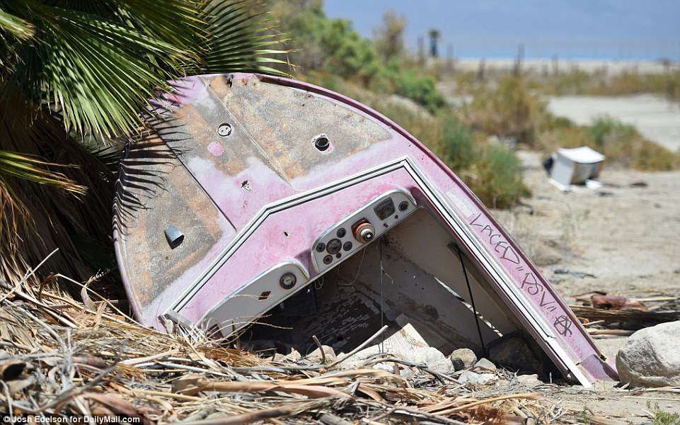  An abandoned and dilapidated boat is seen near a receded shoreline in Salton Sea Beach. This is one of many discarded items that can be found throughout the area that was once the hotspot destination for families and Hollywood stars