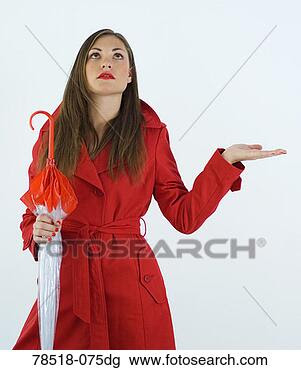 Stock Photo - woman in red trench
coat with umbrella
and expecting
rain. fotosearch
- search stock
photos, pictures,
wall murals, images,
and photo clipart