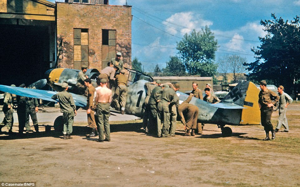 Fascinated American troops examine an abandoned 