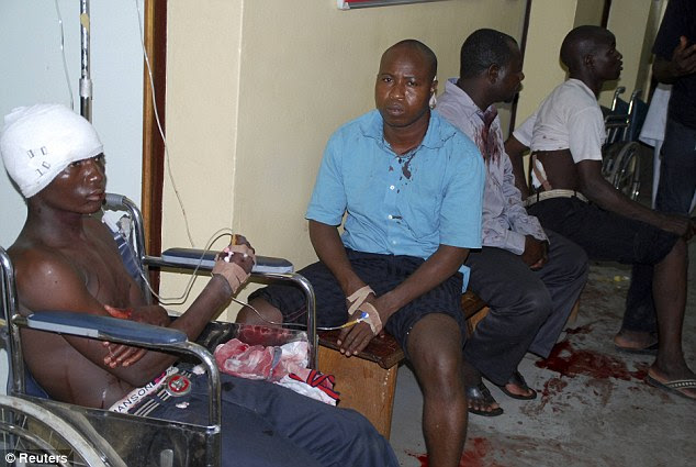 Horror: Surrounded by blood stains on the floor, those injured in the bomb blast waited for treatment at the Maitama general hospital in Abuja, a relatively wealthy city