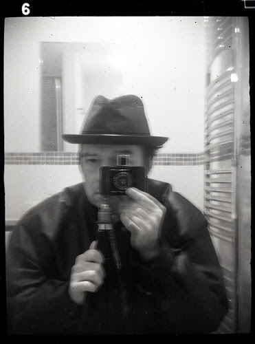 reflected self portrait with Baby Ikonta camera and leather hat by pho-Tony