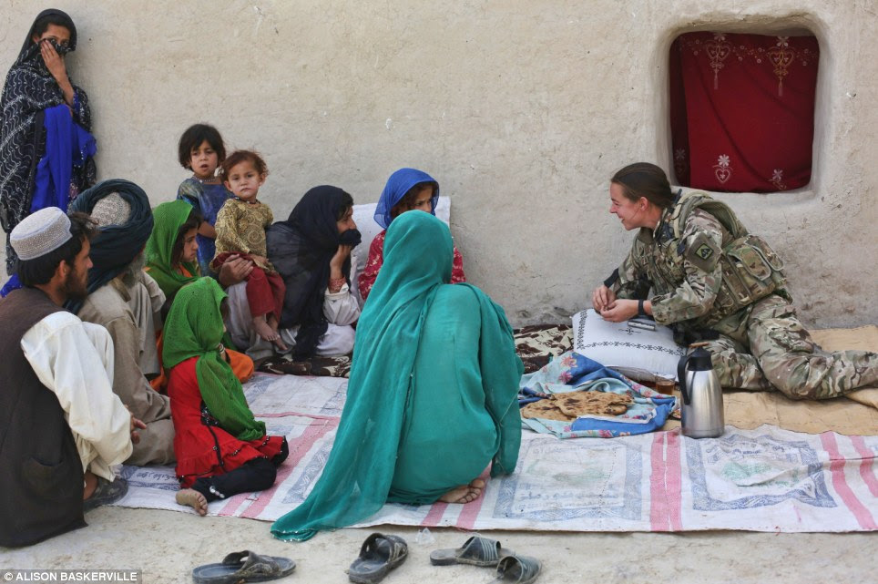 Show and tell: Lieutenant French speaks to a crowd of mostly women. She believes education is key to a brighter future for female Afghans