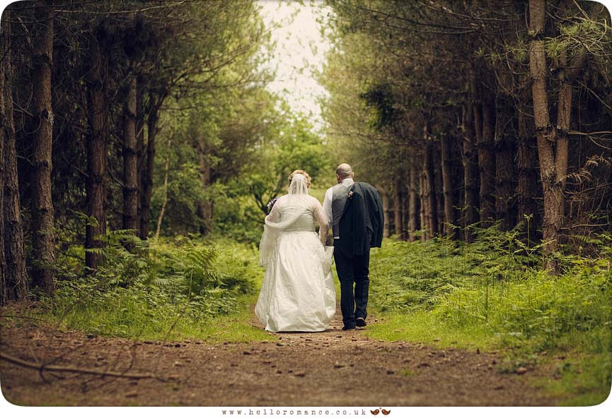 Cute English Wedding Photos Suffolk Vintage Toned Walking away aisle of trees - Hello Romance