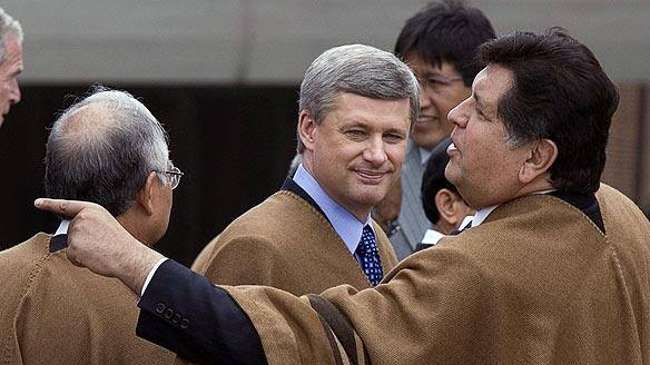 Prime Minister Stephen Harper, centre, wearing a traditional Peruvian poncho at the Asia-Pacific Economic Cooperation summit in Lima.