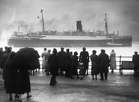 Crowds gather to see the 16,243 ton liner Lancastria, grounded in the River Mersey off Egremont in 1936. 