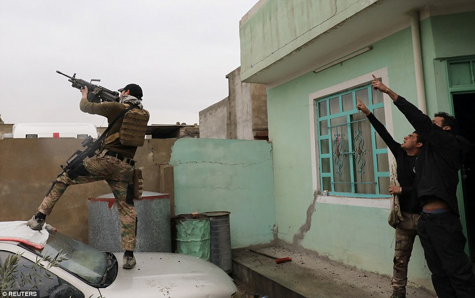 An Iraqi special forces soldier fires at a drone operated by ISIS militants  in Mosul over the weekend