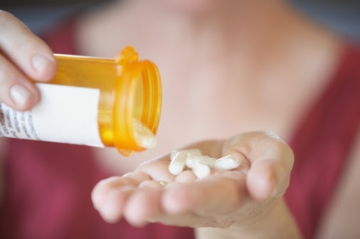 Pills in woman's hand