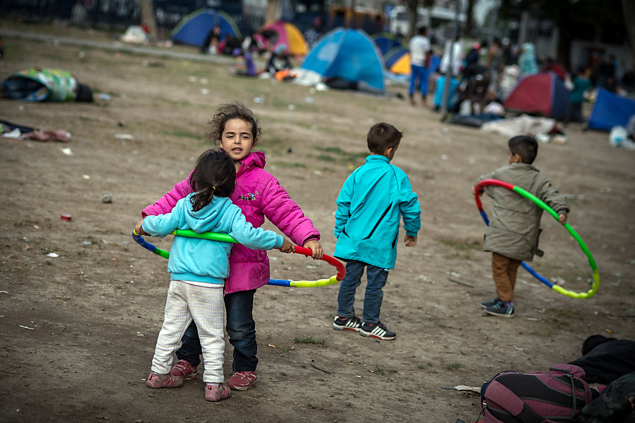 Children play with hula hoops at a park ...Children play with hula hoops at a park where migrants have found temporary shelter in the Serbian capital Belgrade on August 25, 2015. A record number of refugees streamed into EU member state Hungary from Serbia on August 24, police said, just days before Hungary completes a border fence to keep out migrants. A total of 2,093 migrants, the highest ever daily total, crossed the border near the Hungarian town of Roszke, a police statement said. They were part of a wave of around 7,000 refugees whose journey to the European Union had been blocked last week when Macedonia declared a state of emergency and closed its borders after being overwhelmed by the huge influx of people, amid Europe's worst migration crisis since World War II.   AFP PHOTO / ANDREJ ISAKOVICANDREJ ISAKOVIC/AFP/Getty Images