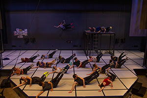 many people on a lying on a stage rehearsing a dance sequence