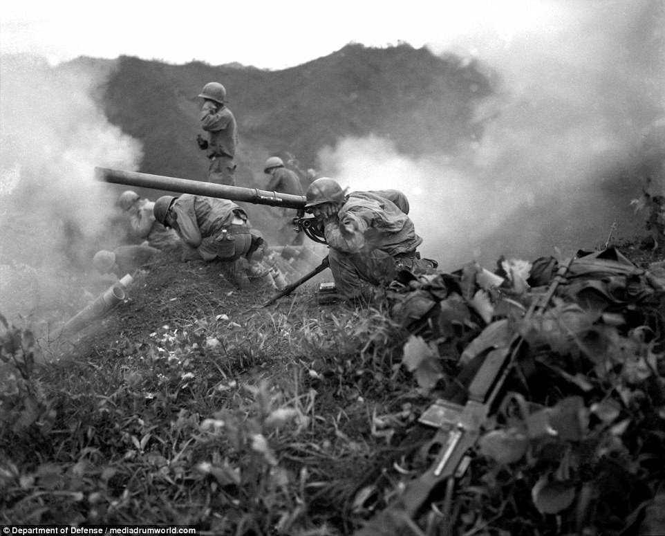 Korea was split into two regions with separate governments in 1948 as a product of the Cold War between the Soviet Union and the United States, who operated in North Korea and South Korea respectively. Pictured above, Pfc Roman Prauty, a gunner with 31st RCT (crouching foreground), with the assistance of his gun crew, fires a 75mm recoilless rifle, near Oetlook-tong, Korea, in support of infantry units directly across the valley on June 9, 1951