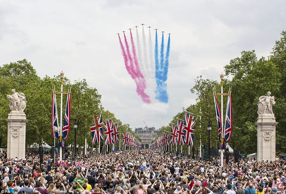 The Royal Air Force Aerobatic Team - the Red Arrows - approaching the Mall, towards Buckingham Palace, part of the celebrations for the Queens Birthday in 2016. Crowds lined the streets to catch a glimpse of the red BAE T1 Hawk jets