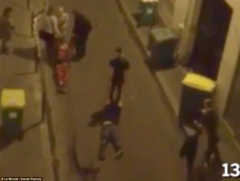 Fleeing the massacre: A dramatic new video has emerged showing desperate Paris terror attack victims escaping from a theatre where jihadi gunmen slaughtered dozens of concert-goers, with some (above) dragging their bleeding friends along the ground to safety