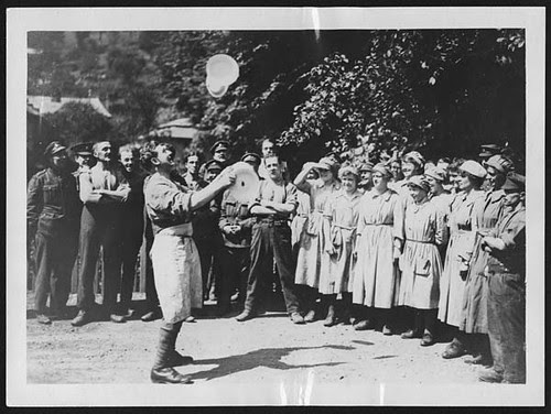 W.A.A.C. cooks in France watching a British soldier doing a juggling turn with plates