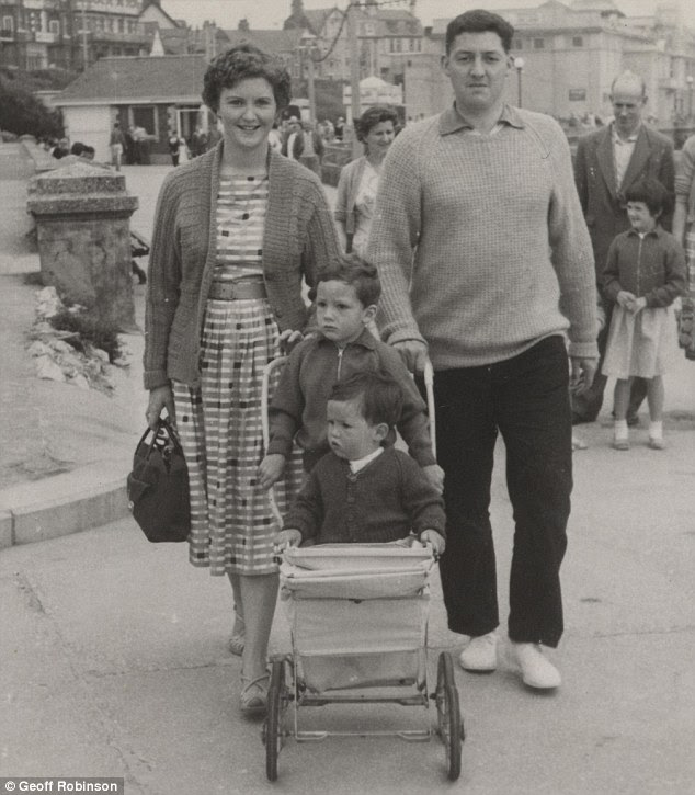 Sharing the load: A couple head out with two young children squeezed into the same stroller in the seaside town of Bridlington, Yorkshire, in 1961