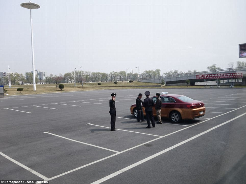 But in North Korea there is just one car parked up and the police seem to be inspecting the driver