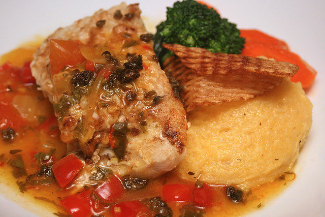Golden Sea Bass: pan-seared and served on creamy black olive polenta, with Spanish sofrito and capers