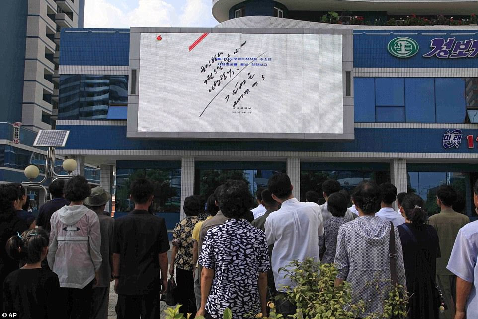Citizens of the North Korean capital Pyongyang gathered around a screen showing the order signed by Kim Jong-Un authorising the nuclear test