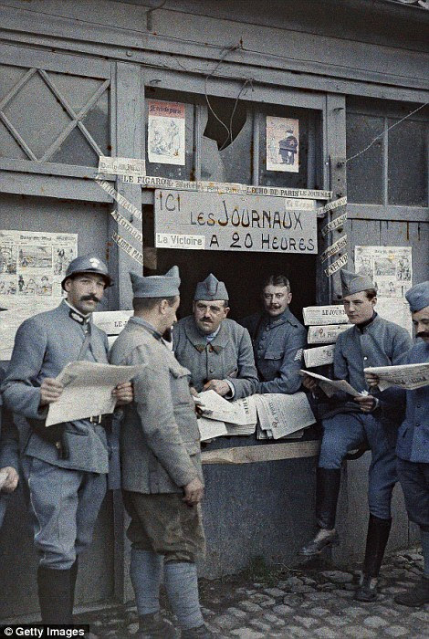 French soldiers buy newspapers in Rexpoede on 6 September