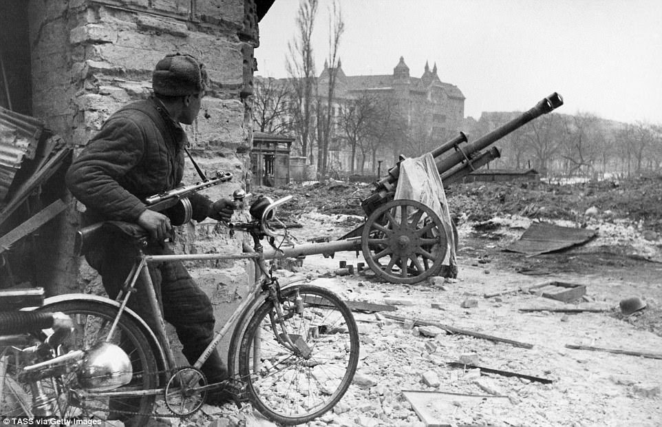 A soldier of the Red Army keeps a lookout over German positions during the battle for Budapest - during the period of Soviet occupation of Hungary in World War II (1944–45) it is estimated up to 600,000 Hungarians (of which were up to 200,000 civilians) were captured  and deported to labour camps in the Soviet Union - of those deported up to 200,000 died. The first deported Hungarians started to return to Hungary in June 1946, with the last returning in the years 1953-1955, after Stalin's death