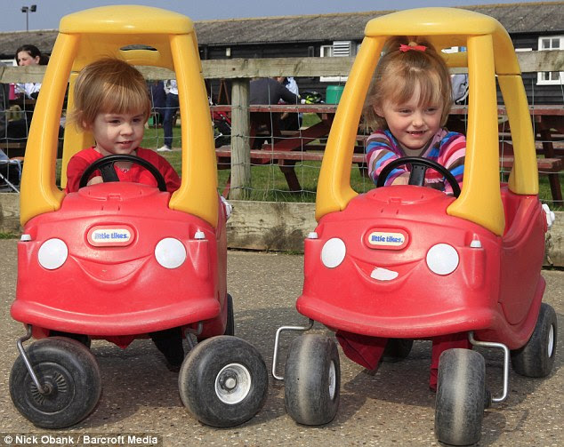 I'll race you: Charlotte (left) and Ellie giggle together as they get behind the wheels of toy cars