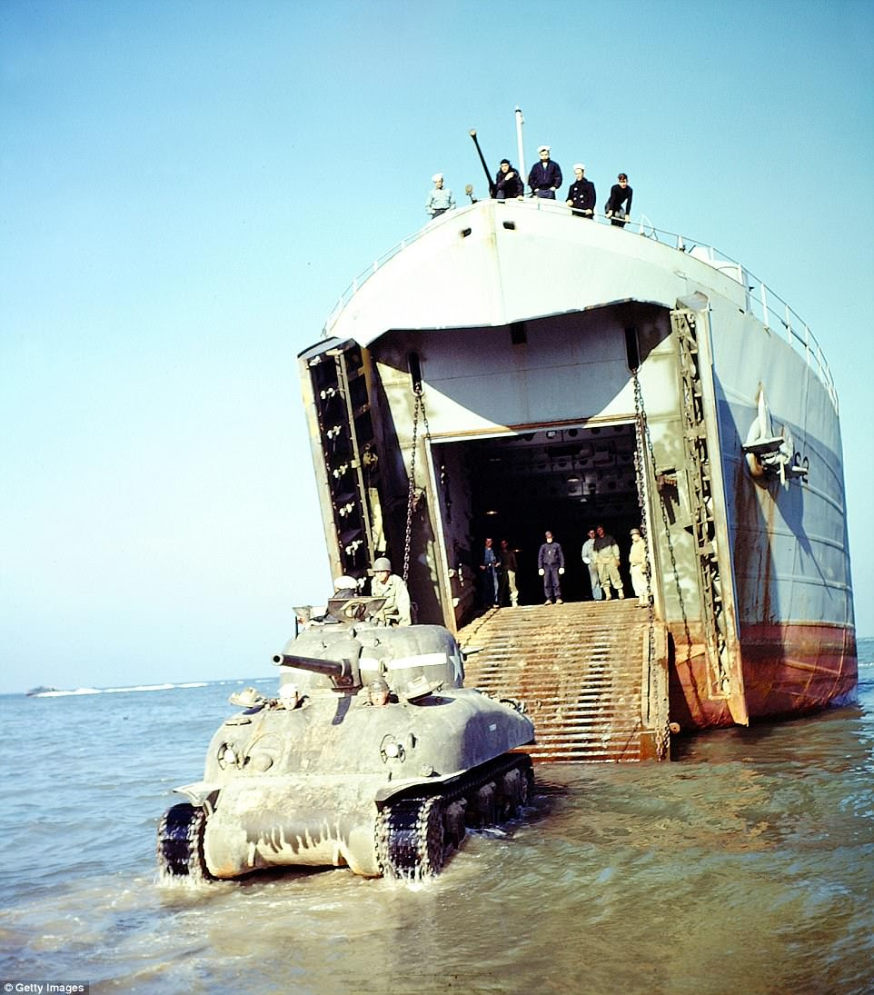 Landing Ship Tank And Sherman, An American Sherman Tank M4A1(76)W is rolling out of the Landing Ship Tank (LST). July 1944. The invasion of France is underway and Wehrmacht positions along the coast of Normandy have been destroyed. Wet ammunition storage is incorporated in this tank. Normandy, France.  (Photo by Galerie Bilderwelt/Getty Images)