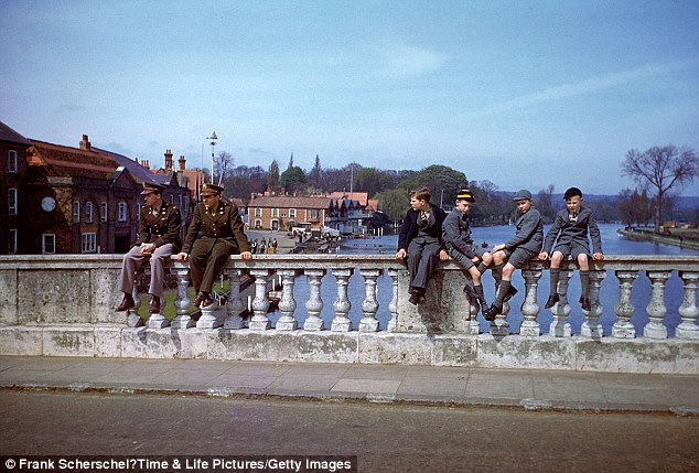 Troops and civilians pass the time on Henley Bridge, Henley-on-Thames, in 1944