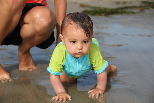 Wet baby on the beach