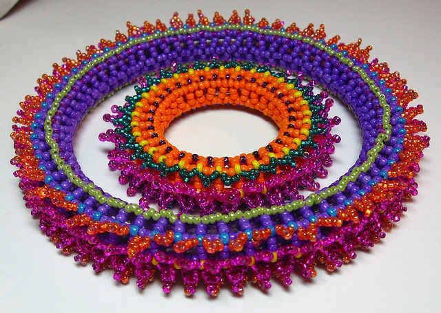 http://www.pinterest.com/pin/58828338856767967/ Bangle bracelet with 11º and 15º seed beads using Right Angle Weave as the base with picots for embellishments.
