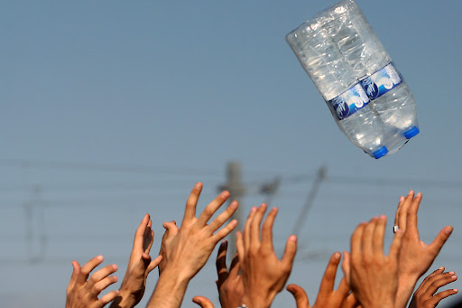 Migrants raise hands to catch bottles of...Migrants raise hands to catch bottles of waters thrown by volunteers of humanitarian organizations as they wait to cross the Greek-Macedonian border near the vilage of Idomeni, northern Greece, on 4 September, 2015. Europe is facing an "unprecedented humanitarian and political crisis" as it struggles with the huge influx of refugees and migrants, the European Commission's vice-president Frans Timmermans said Thursday. "We must find European responses to a problem that cannot be resolved by countries individually," Timmermans said ahead of talks with Greek Prime Minister Vassiliki Thanou on a crisis that has seen more than 230,000 people land on Greek shores this year. AFP PHOTO /Sakis MitrolidisSAKIS MITROLIDIS/AFP/Getty Images
