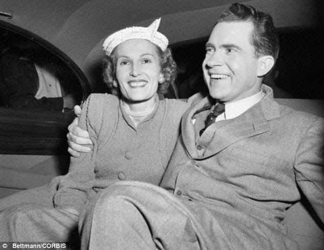 Richard Nixon hugs his wife, Pat, as they leave Republican headquarters in Los Angeles to return to their hotel following his election victory