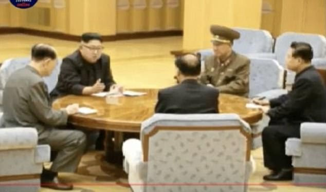North Korean television today released these photos appearing to show Kim Jong-Un signing the order to carry out the test