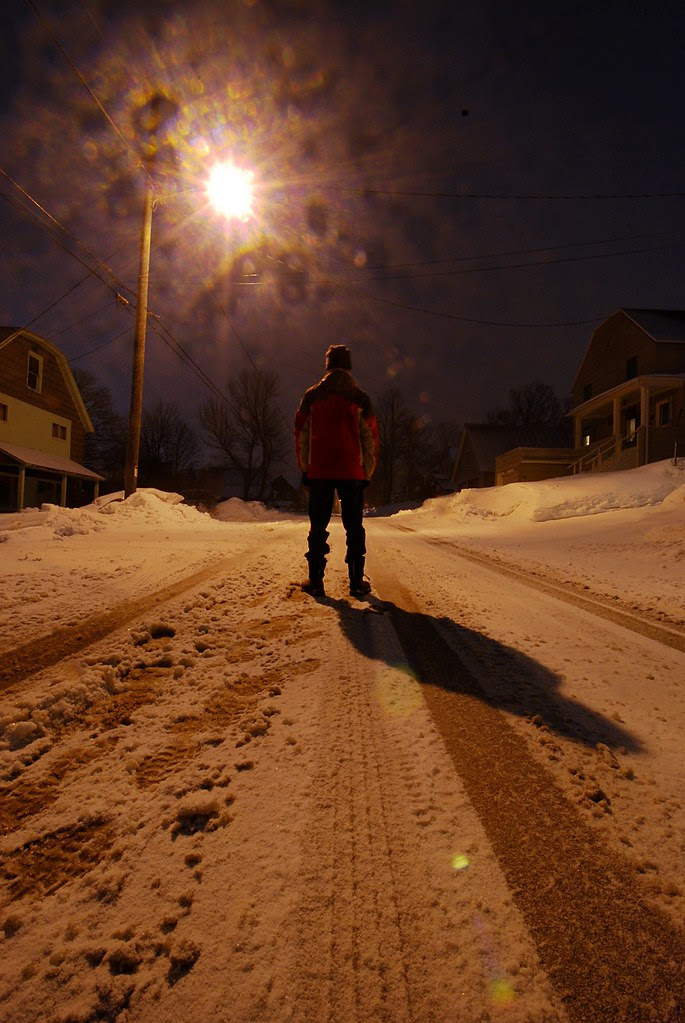 Me, standing in a dark, snowy street.