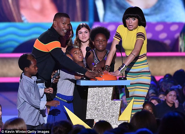 Pushing the button: Onstage the Inglewood Forum, the Material Girl spokesmodel joined Jamie Foxx and several children to present the Blimp for favourite movie actress