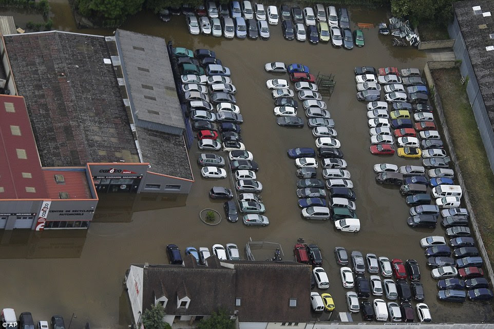 Cars stand in muddy water in a flooded area of the town of Nemours south of Paris. Thousands have been evacuated across France