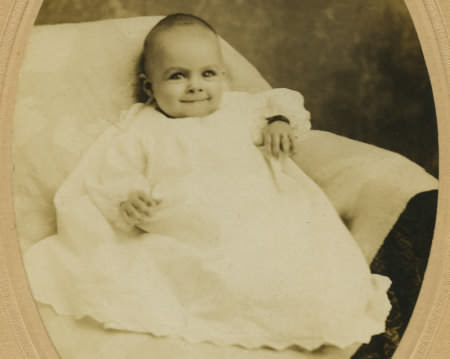 creepy eyed evil baby in a dress