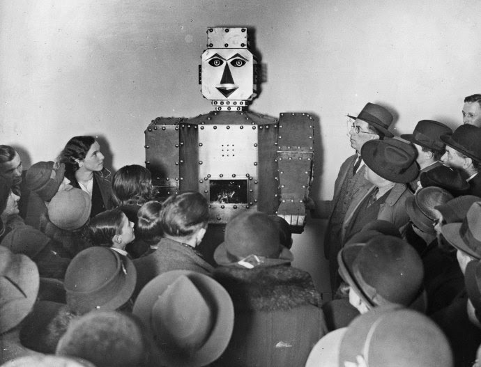 Shoppers admiring a fortune-telling robot at Selfridges, in London.