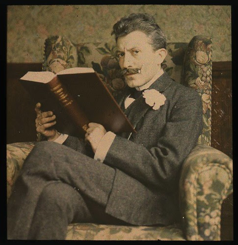 Man with book sitting in chair