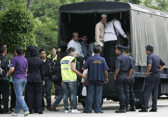 Supporters of the 'Bersih' electoral reform coalition are ushered into a police truck near the National Museum after being detained before a planned Bersih rally in Kuala Lumpur July 9, 2011. Hundreds arrested in Malaysian protest