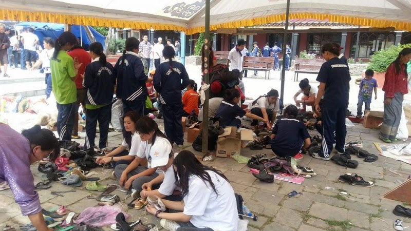 olunteers concentrating on how to recycle the shoes collected during the collection drive. These will soon be sent to corners of Bhutan for distribution. 500 pairs equals 500 smiling faces. Image used with permission.