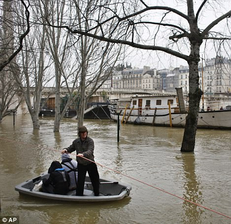 Parisians appear to have taken the flooding in their stride, including these people using a dinghy to make their way along the river